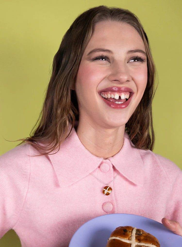 Laughing woman wearing the hot cross bun necklace