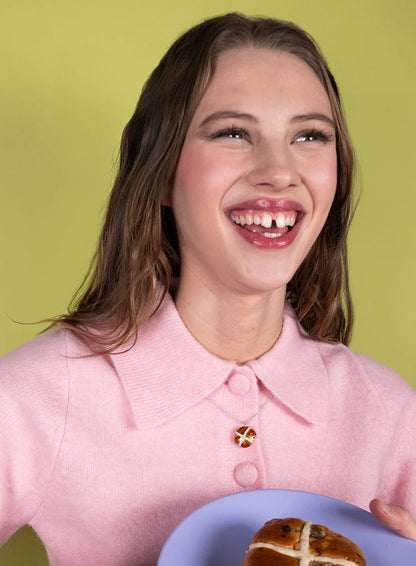 Laughing woman wearing the hot cross bun necklace