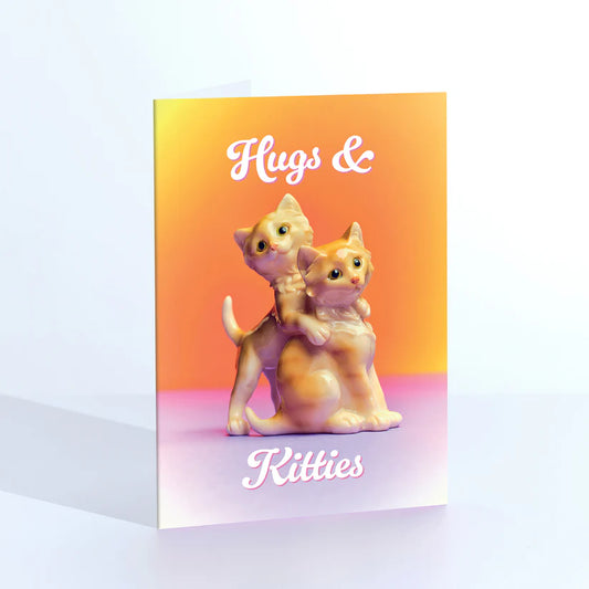 Ornament card: two kitten figurines hugging, with 'Hugs & kitties' on orange