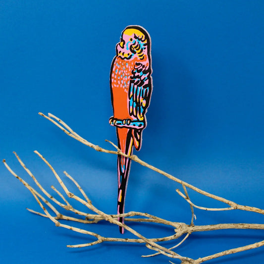 Pink and orange leather budgie bookmark perched on a branch