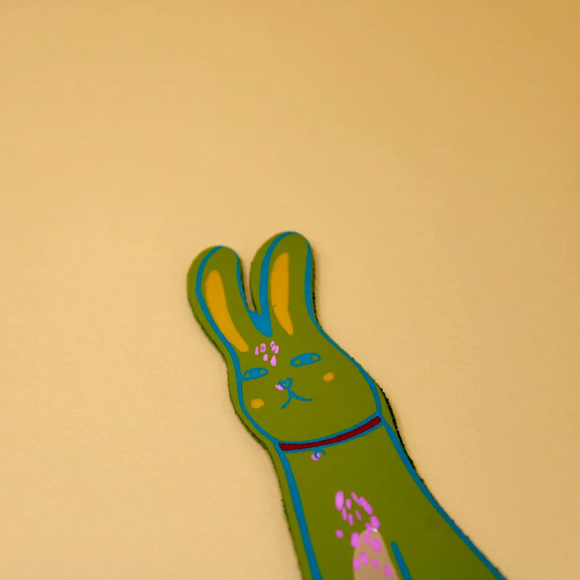 Apple green leather bunny bookmark on a yellow background