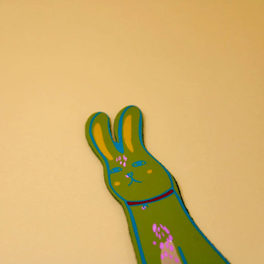 Apple green leather bunny bookmark on a yellow background