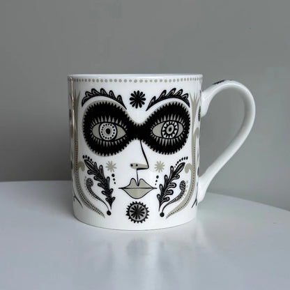 Lush Designs Masquerade mug: a black and gold face with a mask and patterned leaves