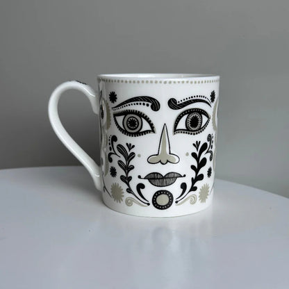 Other side of the Masquerade mug with a different patterned face