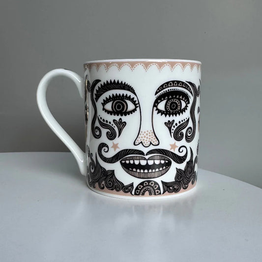 Lush Designs Moustache mug: a black and gold face with a big moustache and beard