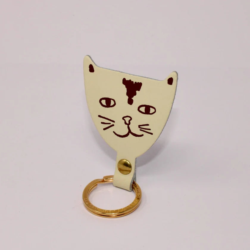 Ark cream leather cat head key fob with a printed cat face and gold ring