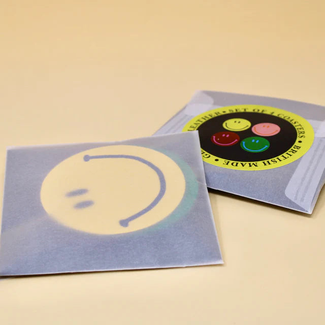Smiley coasters in their packaging