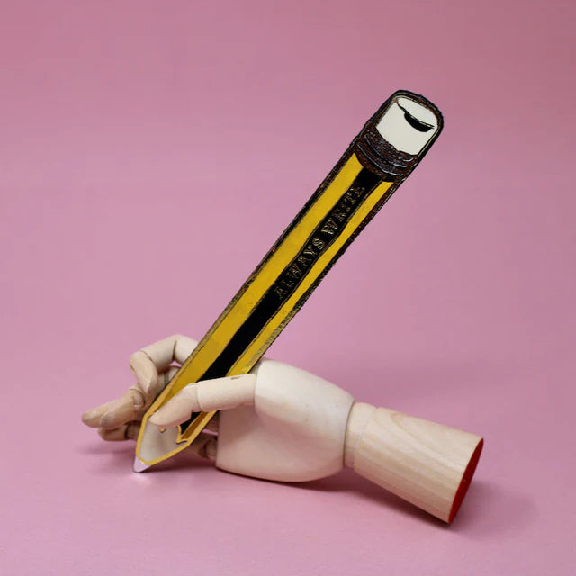 Black and yellow pencil-shaped leather bookmark held by a wooden hand