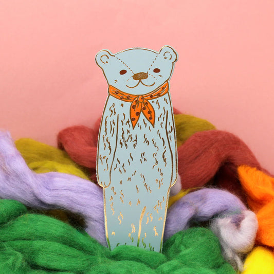 Ark light blue bear bookmark with an orange neckerchief among coloured wool