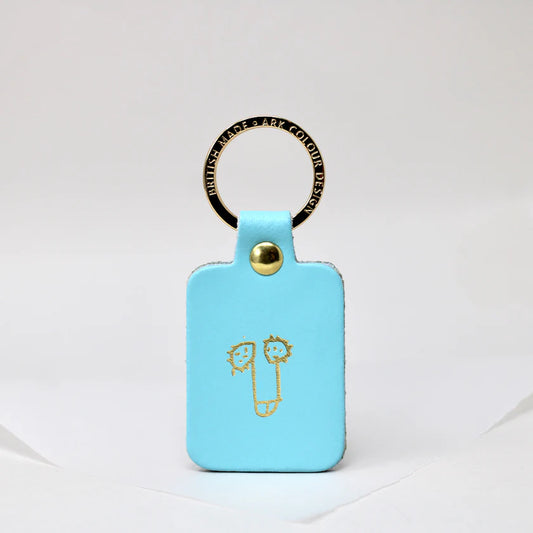 Turquoise leather key fob with a gold cartoon penis