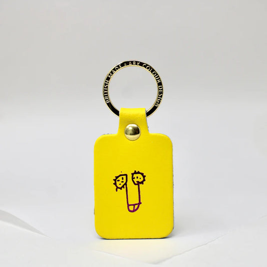 Yellow leather key fob with a cartoon penis