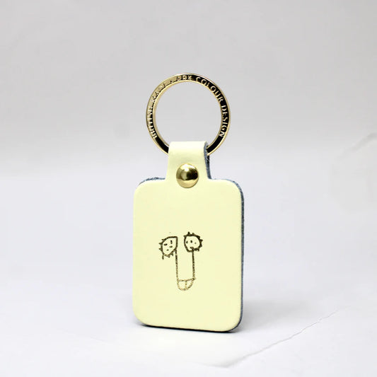 Ark Knob Fob key ring: a cream leather fob with a gold-printed cheeky doodle