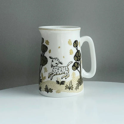 Lush Designs jug with a leaping lamb among dark trees and gold flowers