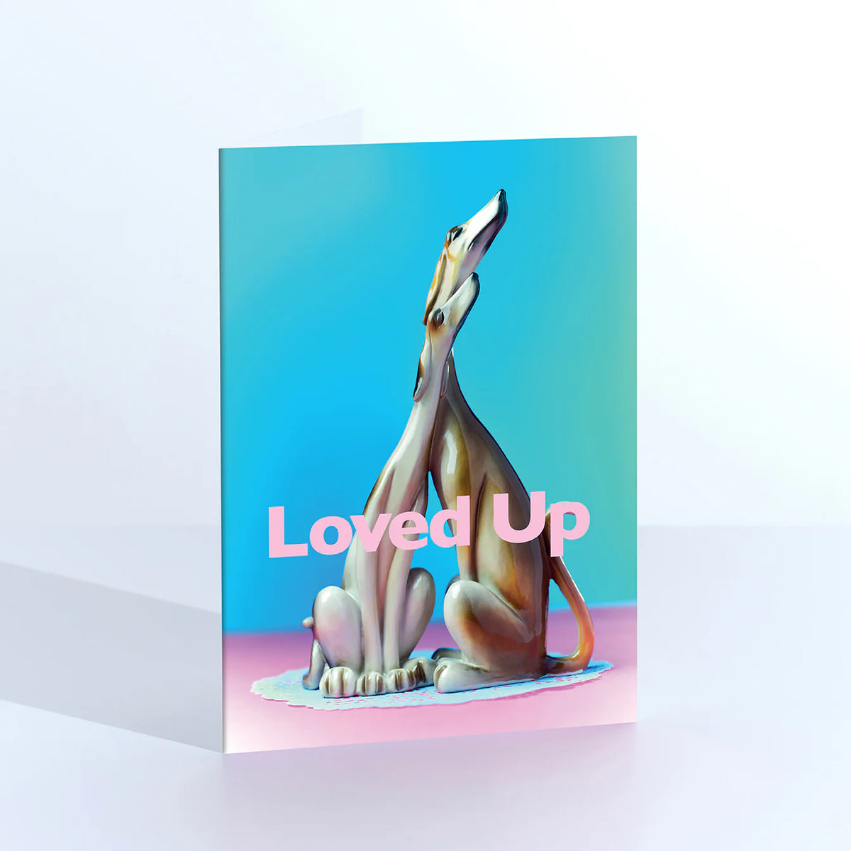 Ornament card: a vintage greyhound figurine, with 'Loved up' on blue