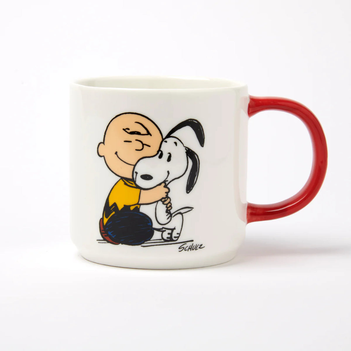 Peanuts Happiness Is a Warm Puppy mug: Charlie Brown hugging Snoopy, with a red handle