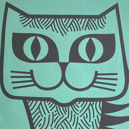 Close-up of the cat's face on the teal tea towel