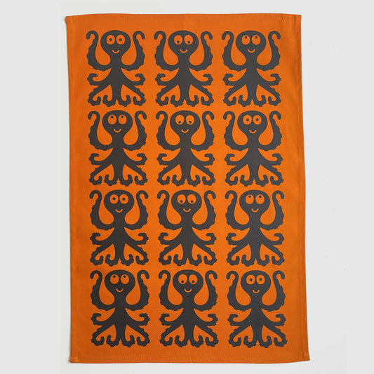 Magpie x Hornsea orange tea towel with a pattern of black octopuses
