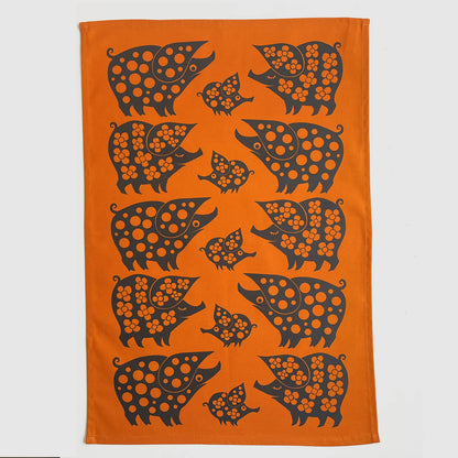 Magpie x Hornsea orange tea towel with a pattern of black piggy families