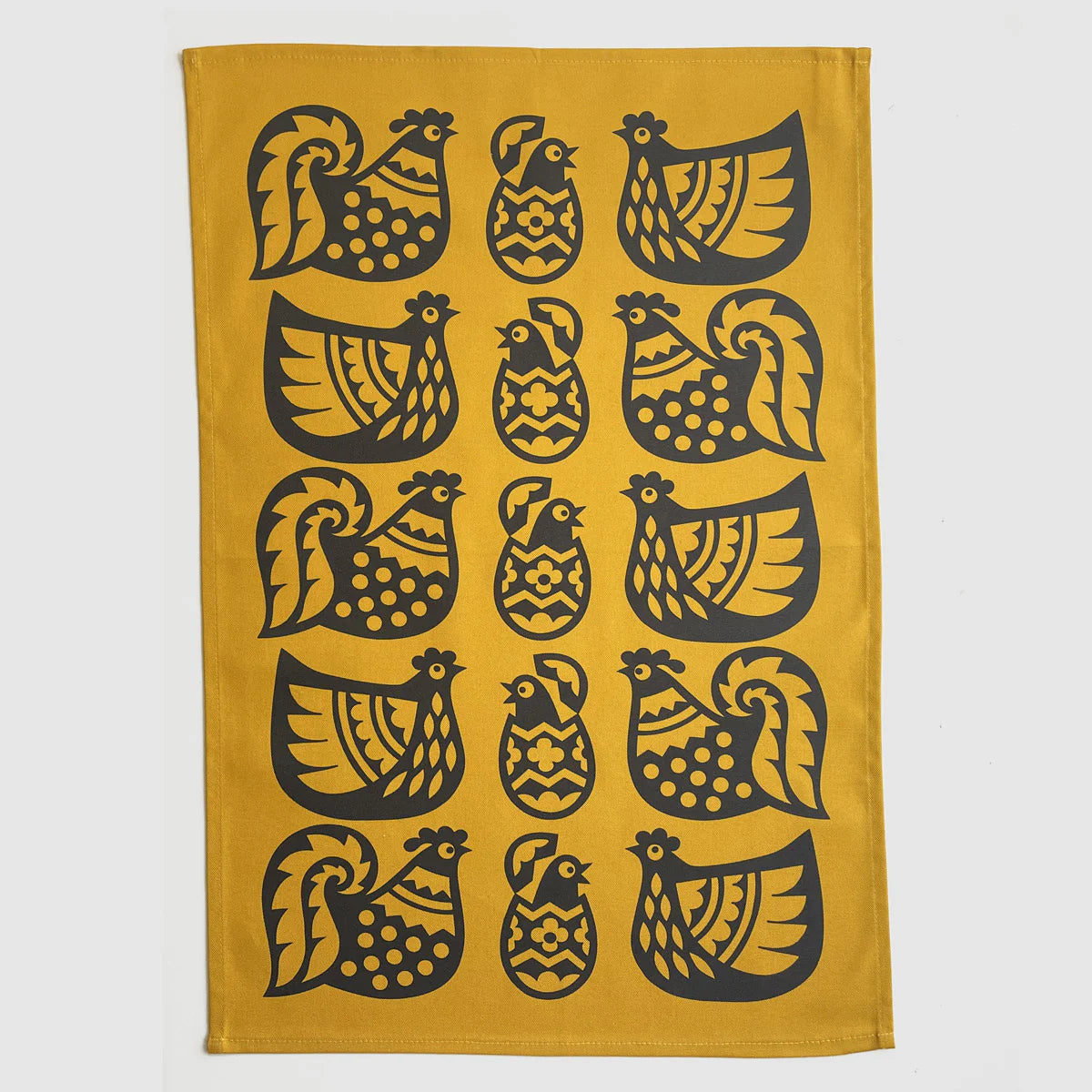 Magpie x Hornsea yellow tea towel with a pattern of black chickens and eggs