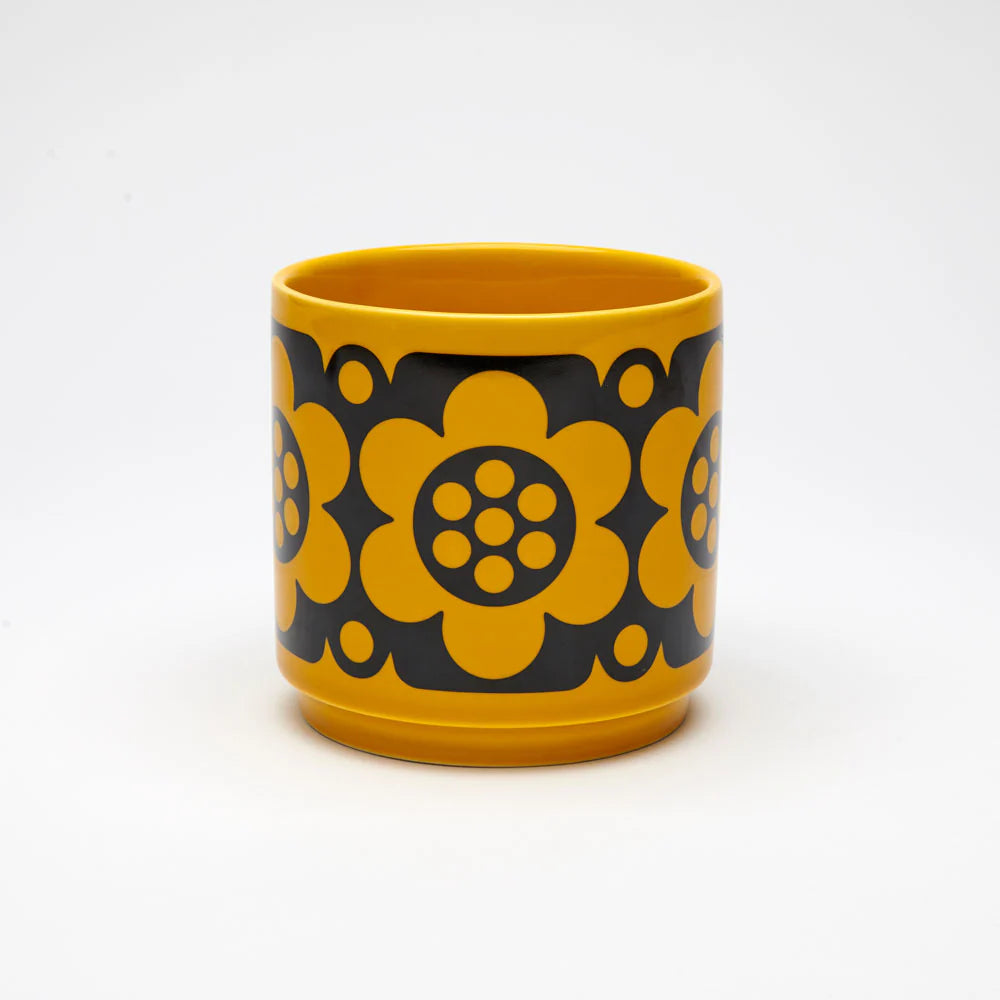 Small mustard plant pot with a black geometric flower pattern