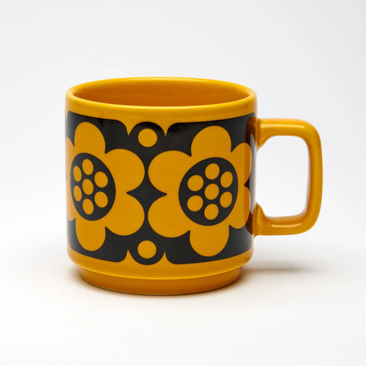 Magpie x Hornsea mug in yellow with a black band of bold yellow geometric flowers