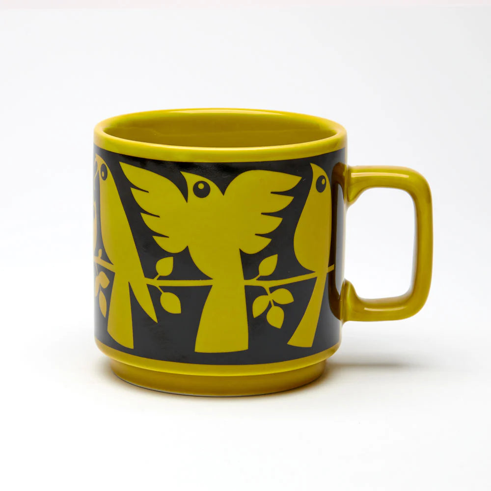 Magpie x Hornsea chartreuse mug with a black band of stylised birds on branches