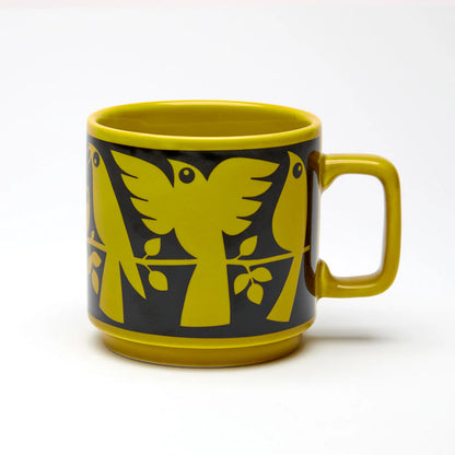 Magpie x Hornsea chartreuse mug with a black band of stylised birds on branches