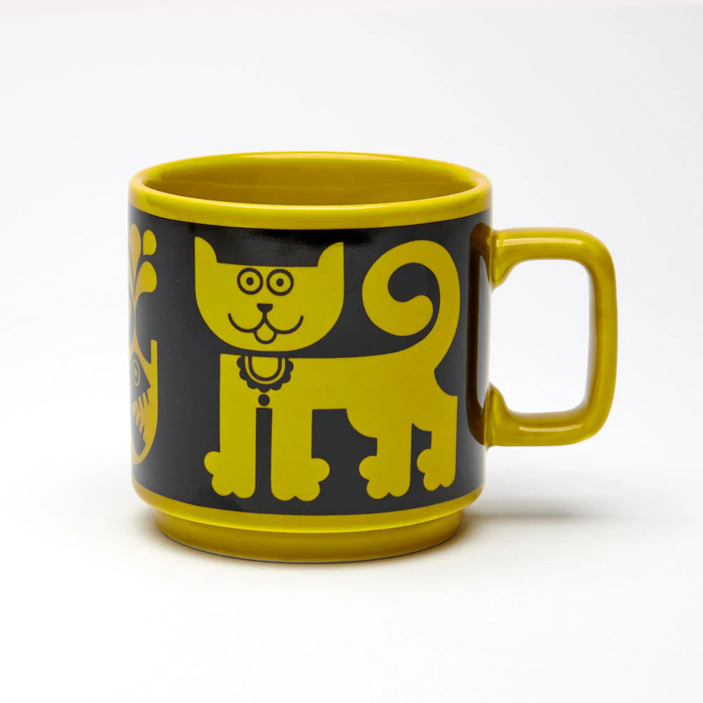 Magpie x Hornsea mug in chartreuse with a black band showing a cat and a piranha
