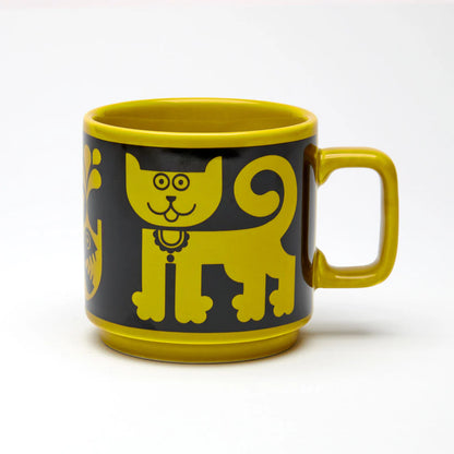 Magpie x Hornsea mug in chartreuse with a black band showing a cat and a piranha
