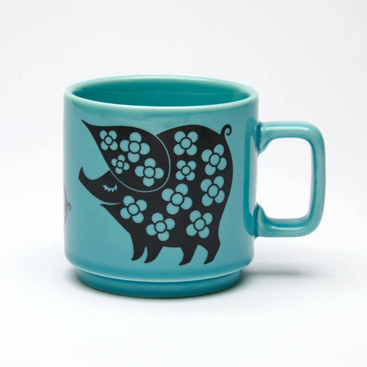 Teal mug with black pigs covered in flowers