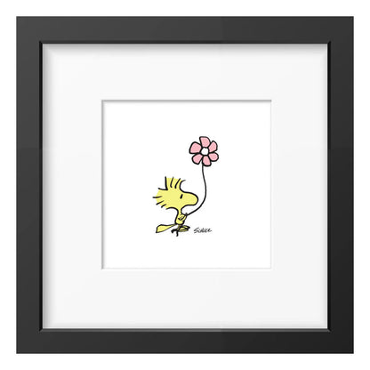 Peanuts framed print: Woodstock holding a pink flower, in a black frame