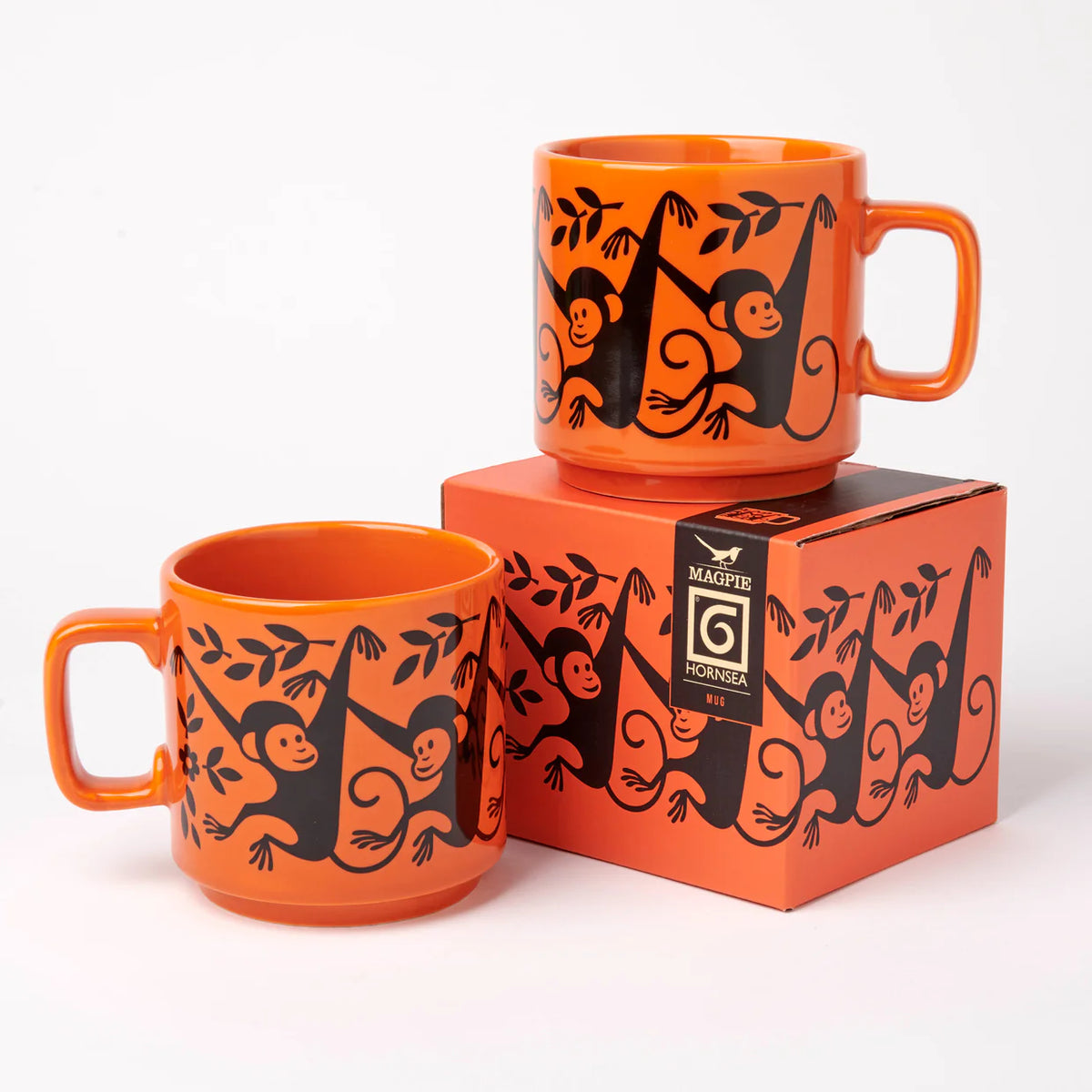 Two orange monkey mugs with their gift box