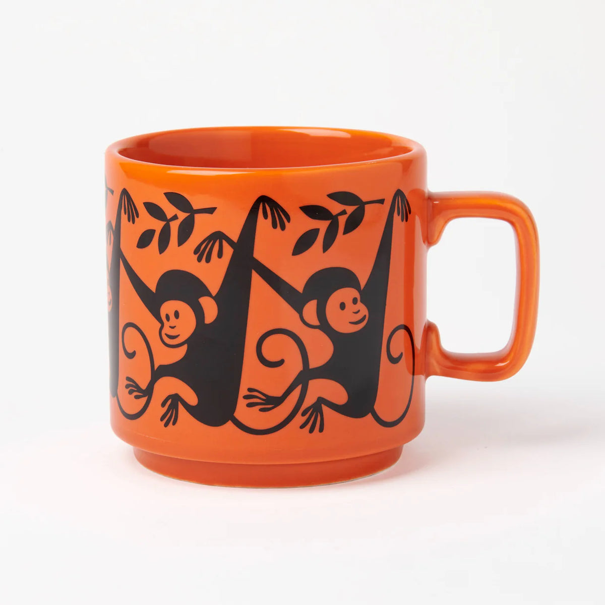 Magpie x Hornsea orange mug with black monkeys hanging from branches