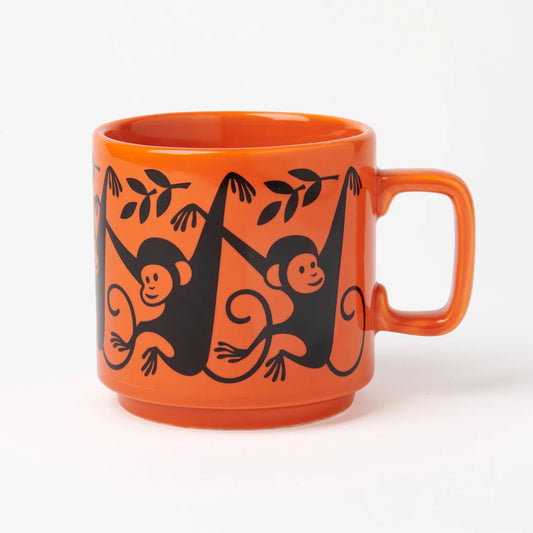 Magpie x Hornsea orange mug with black monkeys hanging from branches