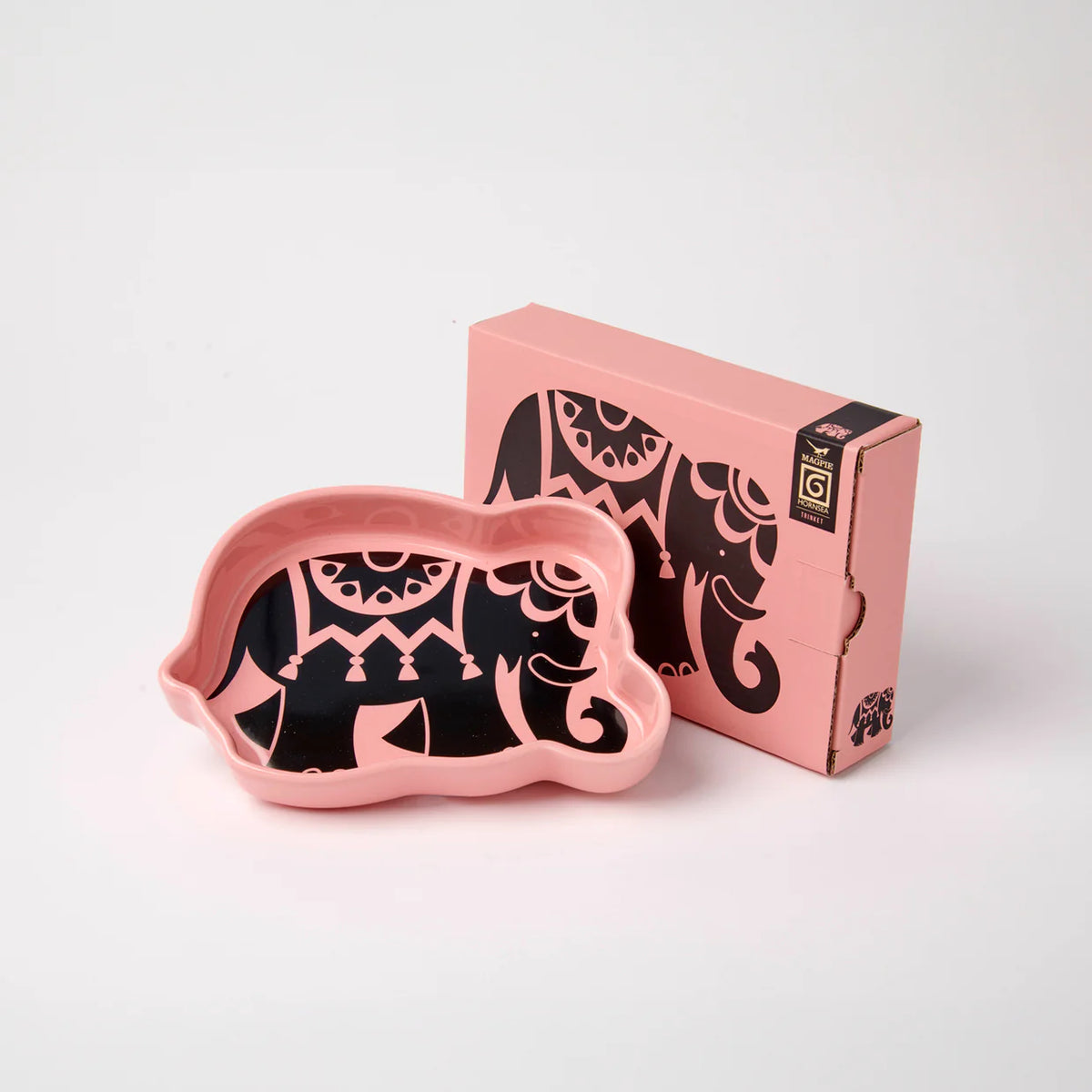 Magpie x Hornsea pink elephant-shaped trinket tray with a black patterned elephant, beside its box