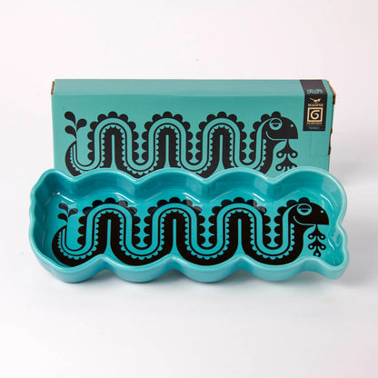 Magpie x Hornsea turquoise trinket tray with a black Loch Ness monster, beside its box