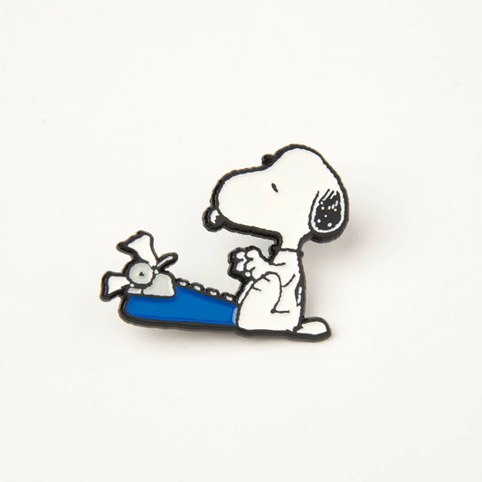 Peanuts enamel pin: Snoopy typing at a blue typewriter