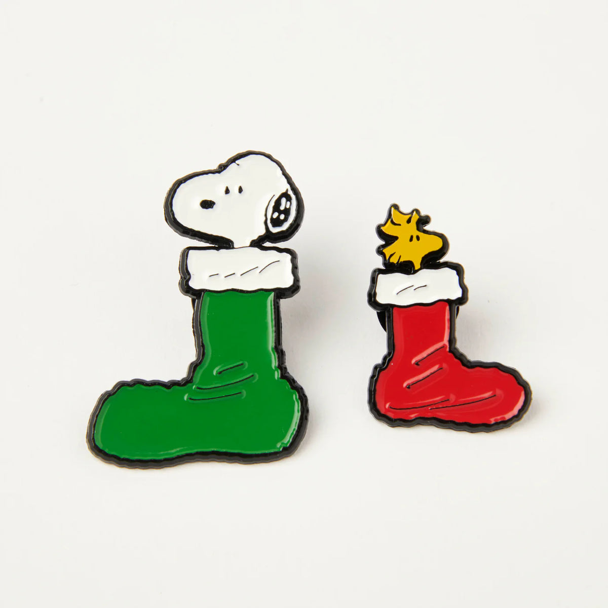 Peanuts Christmas stockings enamel pins: Snoopy in a green stocking and Woodstock in a red one