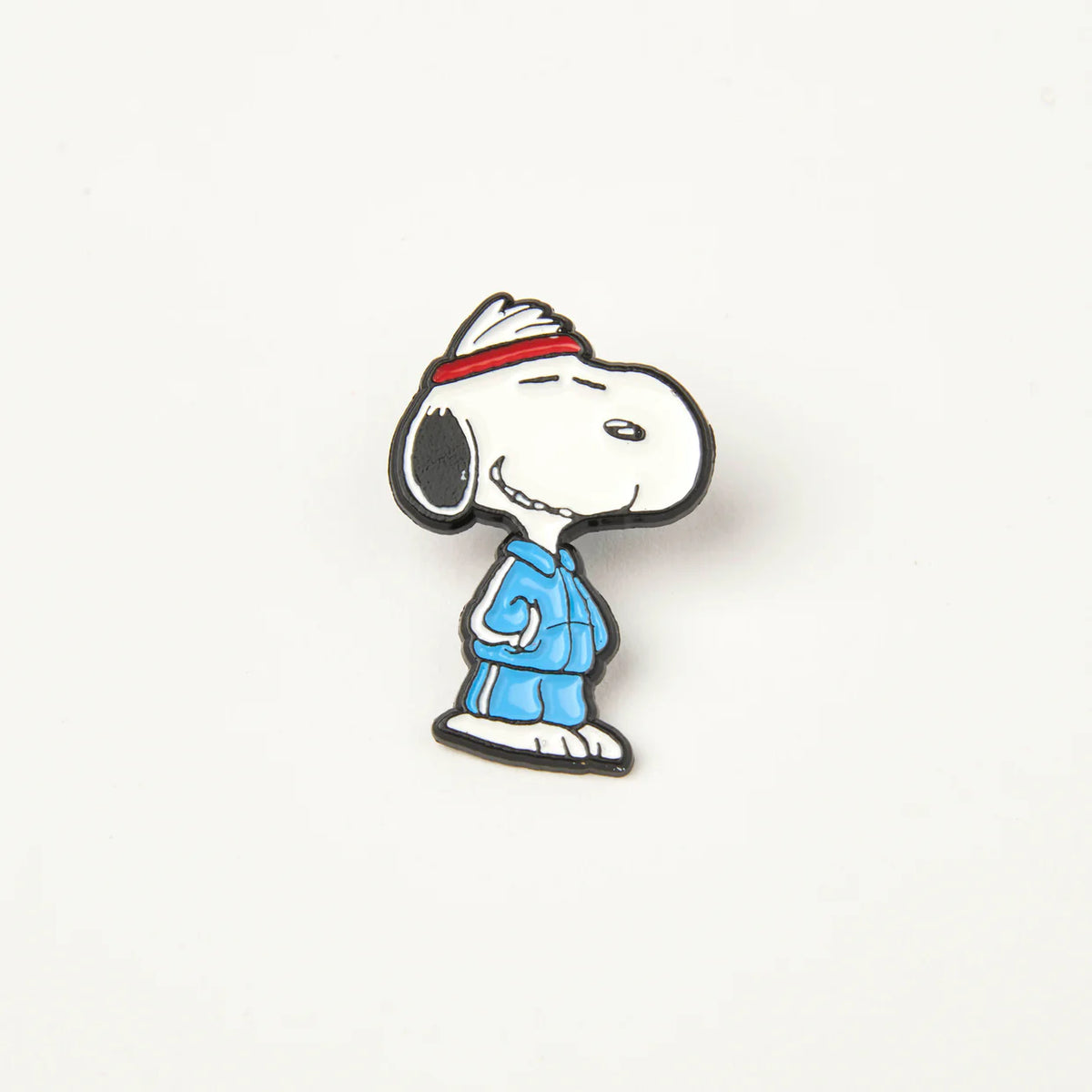 Peanuts Track Star enamel pin: Snoopy in a red headband and blue tracksuit