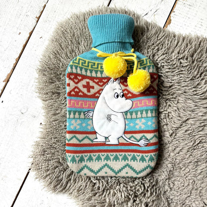 Moomin hot water bottle on a grey sheepskin rug