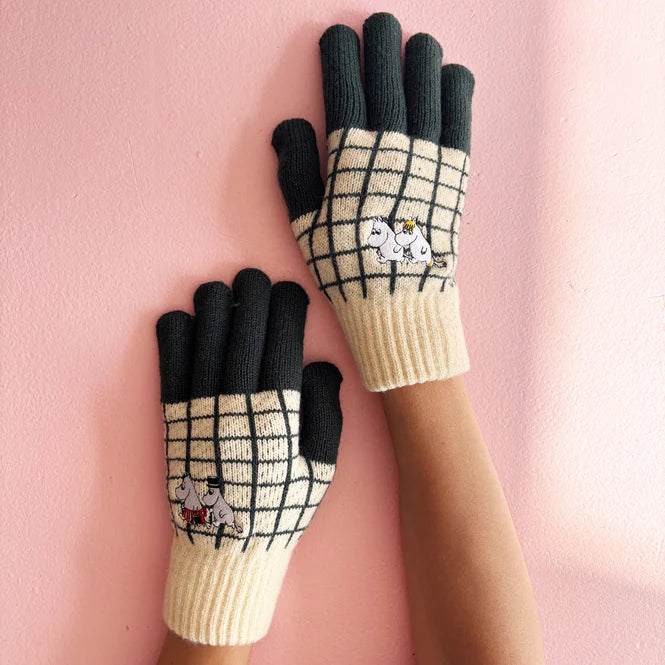 Moomin gloves with a cream and black check, black fingers and Moomin embroidery, worn