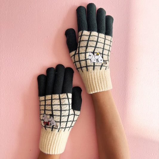 Moomin gloves with a cream and black check, black fingers and Moomin embroidery, worn
