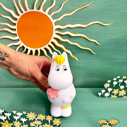 Hand holding the Snorkmaiden light against a painted sun