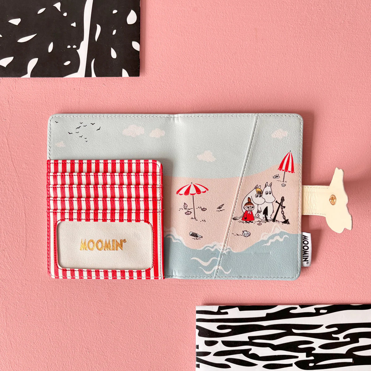 Beach passport holder opened, showing a striped card pocket