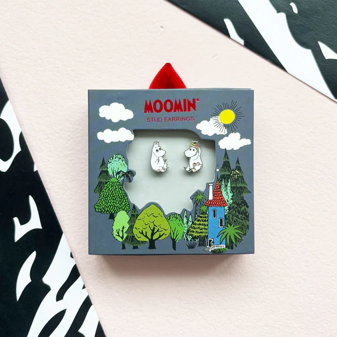 Moomin charm stud earrings in their box with a Moominvalley scene