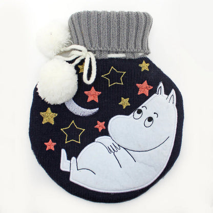 Round navy knitted hot water bottle with Moomintroll asleep on a crescent moon among stars