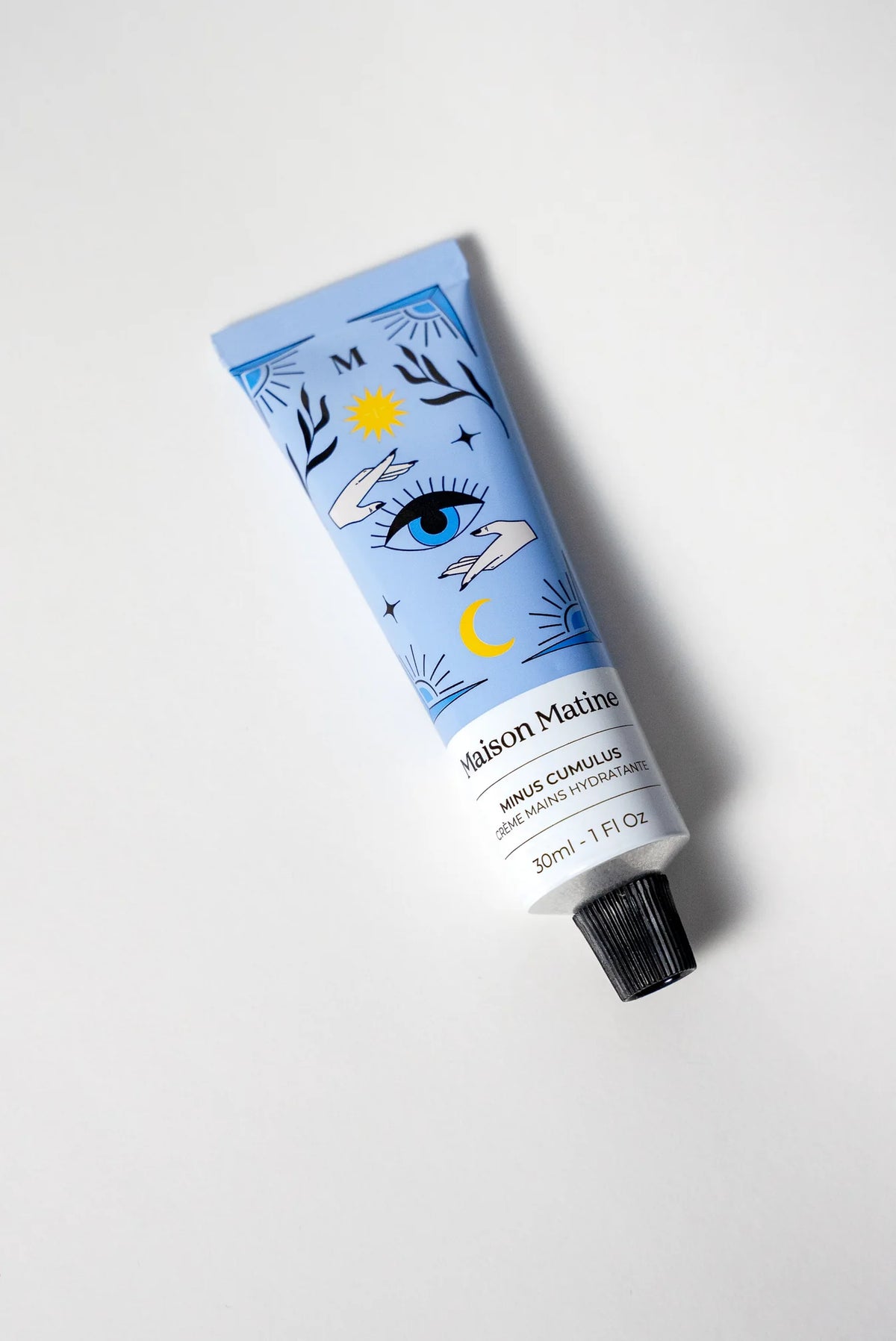 Maison Matine Minus Cumulus hand cream in a blue tube with an eye illustration