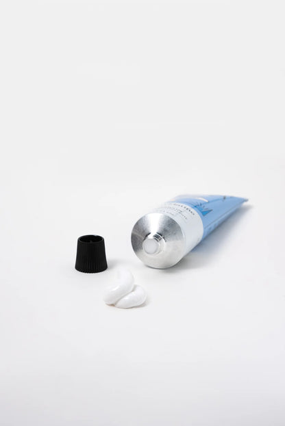 Hand cream tube with its cap off and a dab of cream