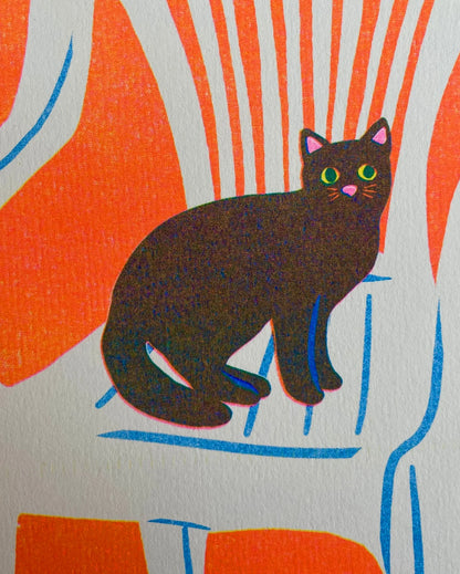 Close-up of the black cat on the chair