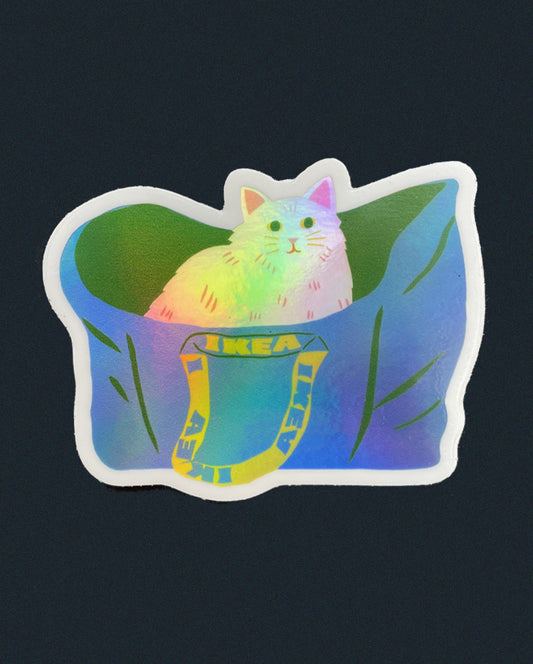Naomi Wilkinson holographic sticker of a white cat sitting in a blue IKEA bag